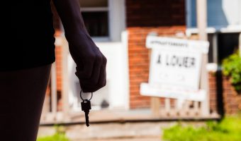 Young Woman standing in front of her new apartment